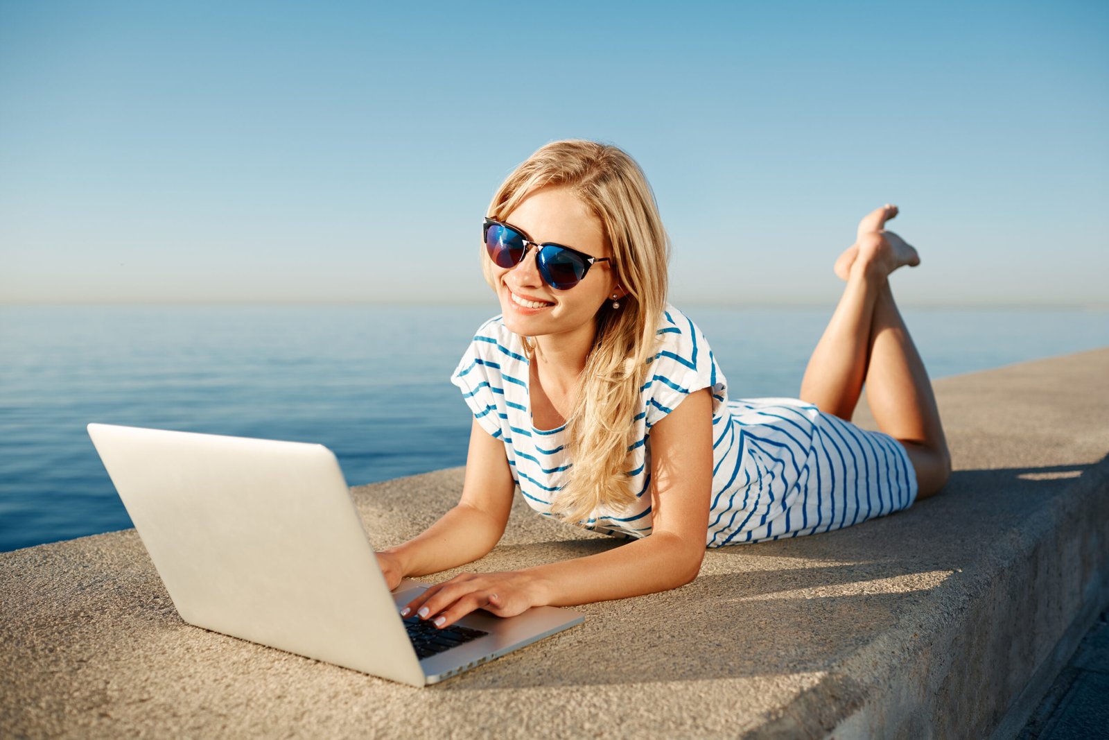 Woman_working_outside_beach_work_life_balance_RezzyCheck