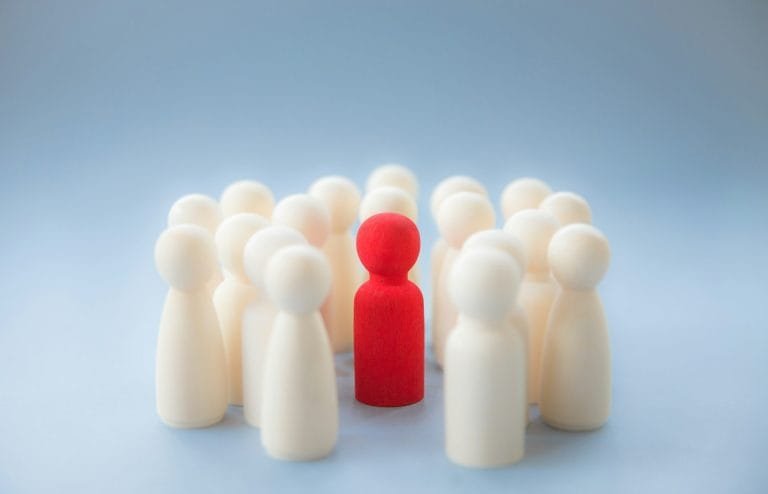 A group of generic people surrounding a diverse individual following the RezzyCheck resume tips.