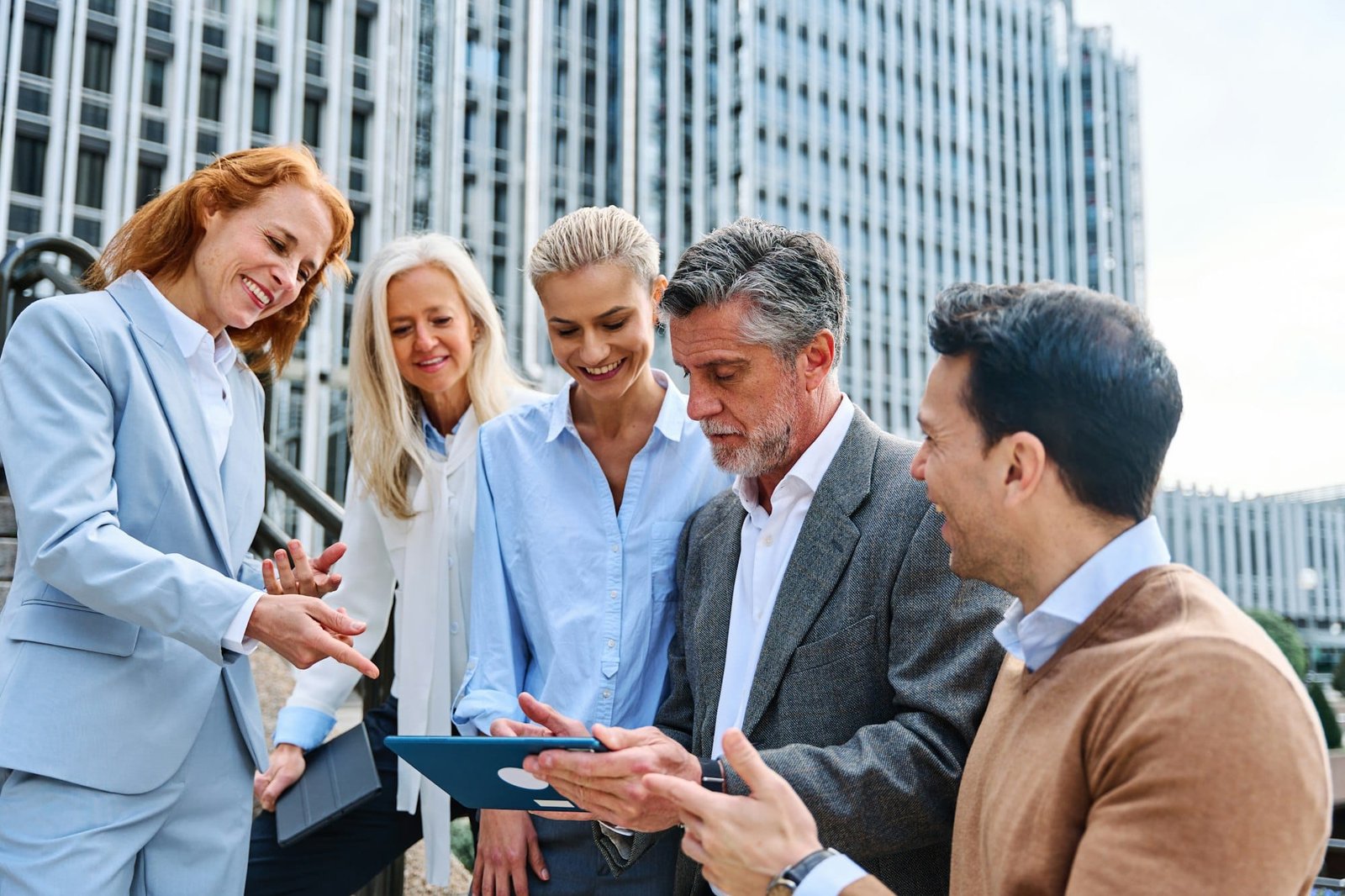 People using a tablet during a business meeting